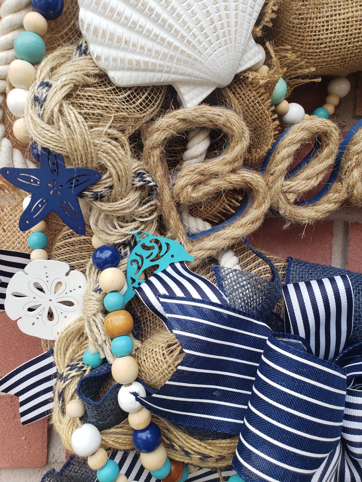 Beach Life wreath with an anchor, starfish and sand dollars. Navy blue, aqua and burlap