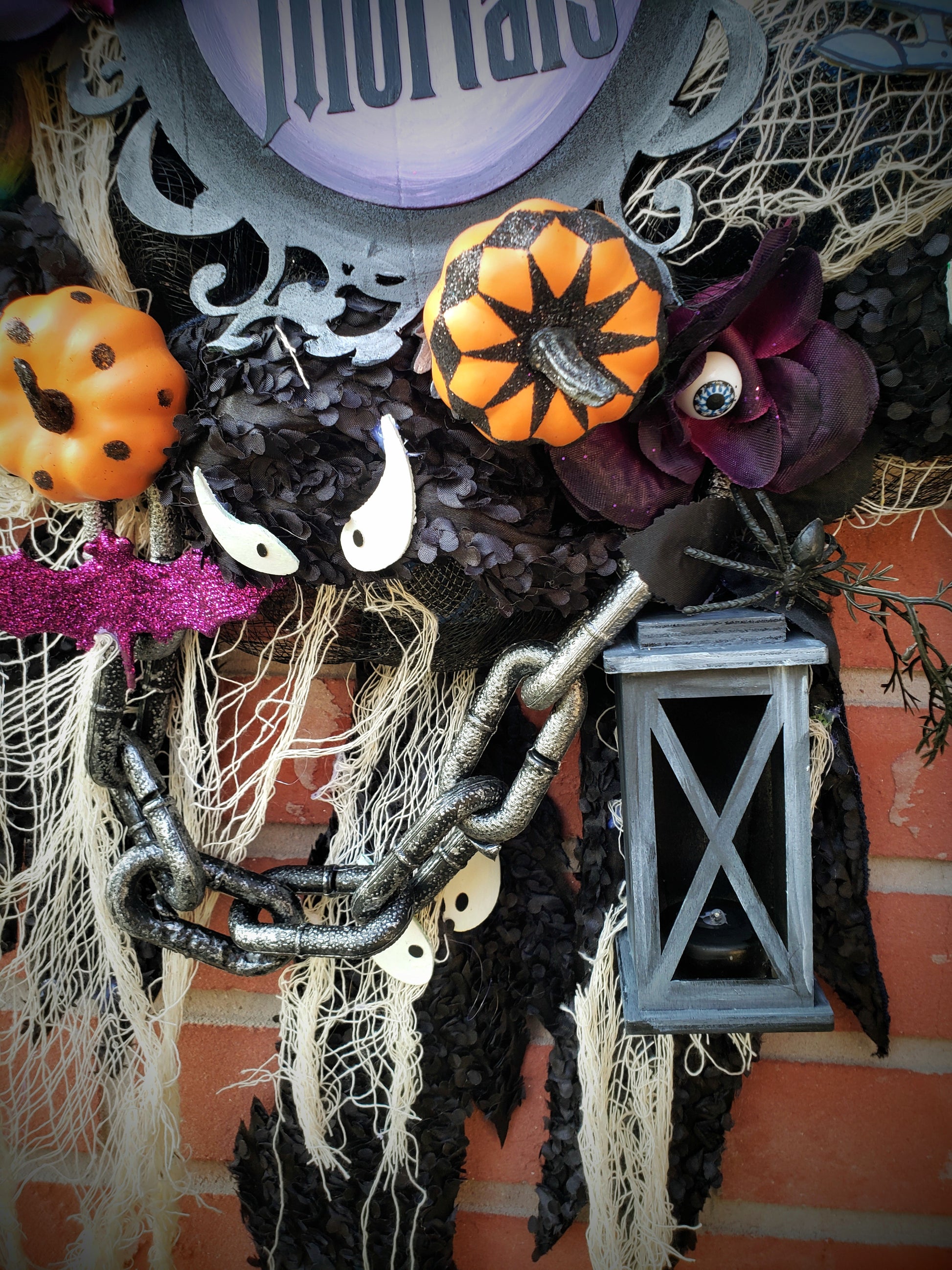 Haunted Mansion wreath with hitchhiking ghosts, madame Leota, welcome Foolish Mortals and glow in the dark eyes 