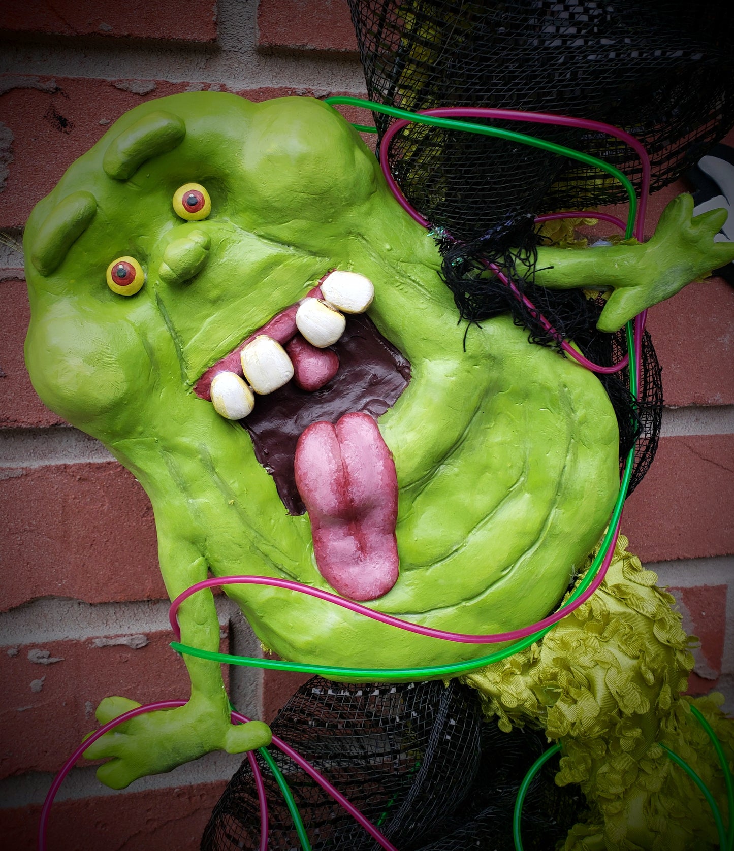 Clay slimer mounted in Ghostbuster's wreath