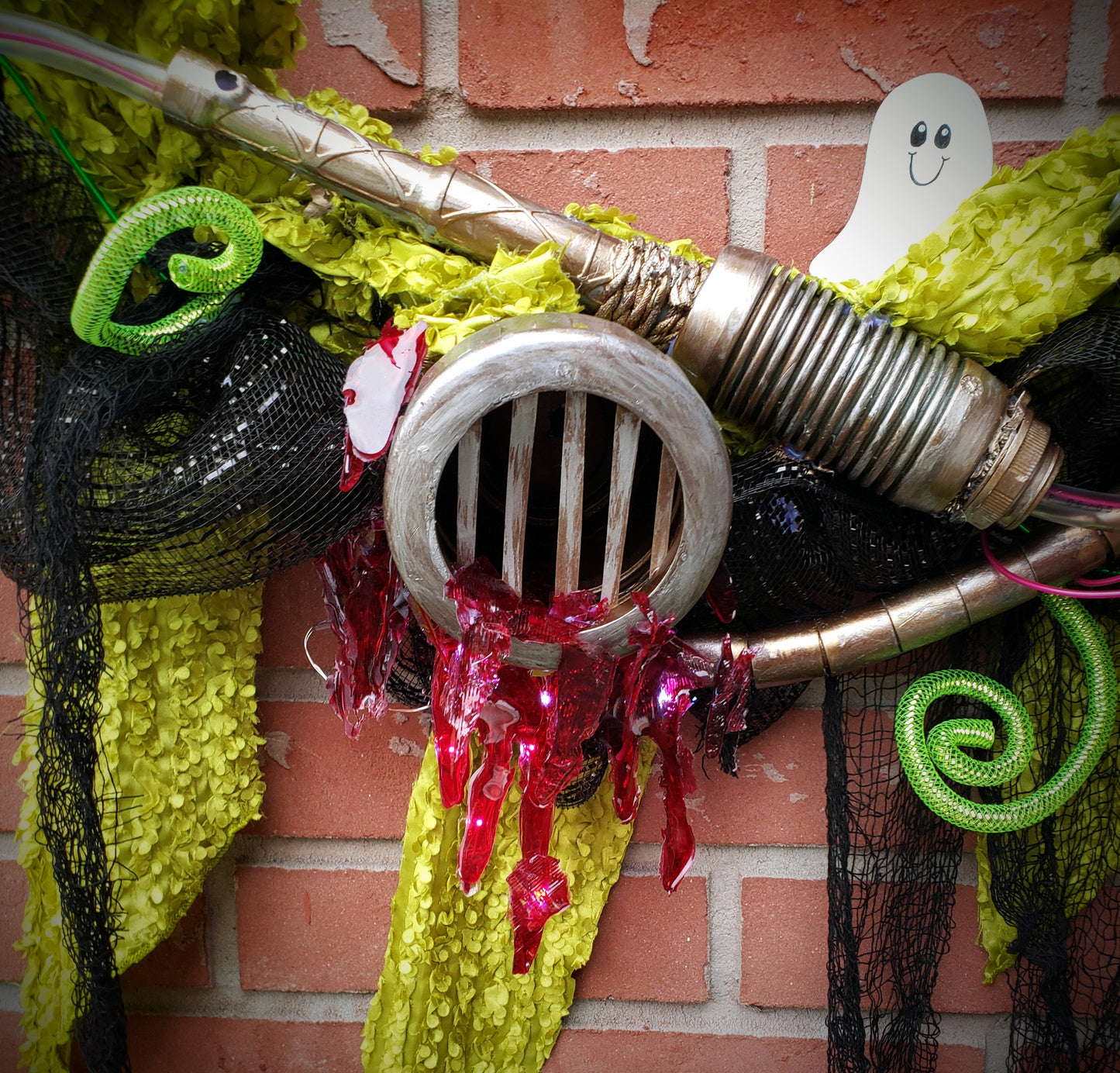 Ghostbusters wreath with NYC drain dripping ectoplasm illuminated with lights