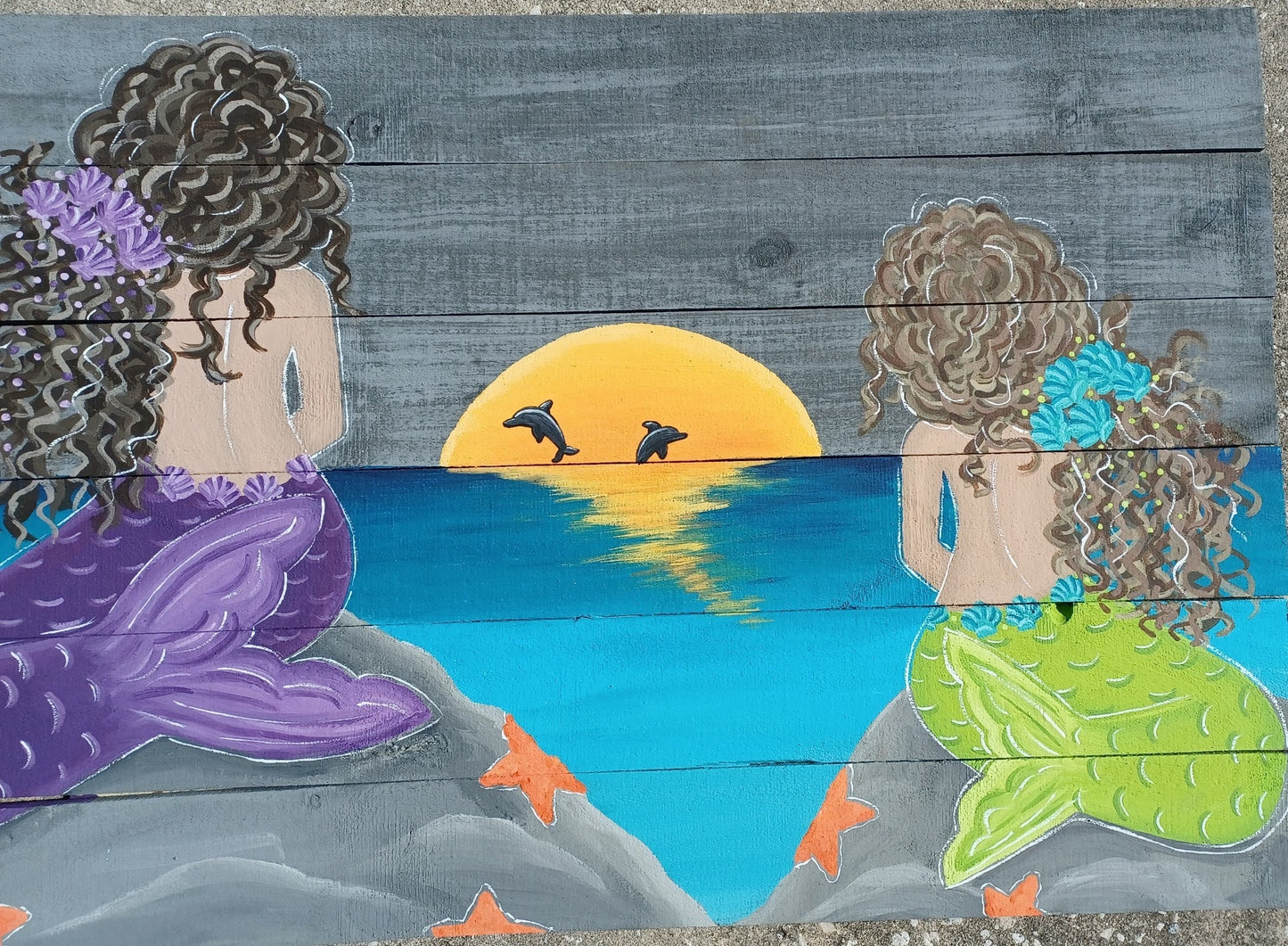 Custom painting of mermaids on wood boards